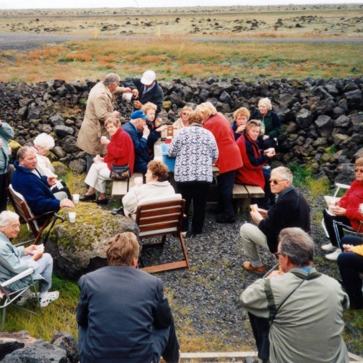 Á þessari mynd er Ragga lengst til hægri á ferðalagi með eldriborgurum og eru þau líklega í dagsferð þar sem tekið var með nesti og höfð gæðastund í náttúrunni.