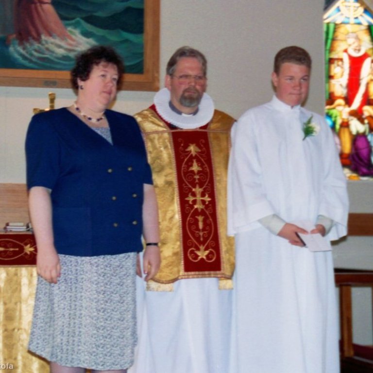 Fermingardagur Sigurðar Tómasar Helgasonar, hann er hér með móður sinni Patricia Ann Heggie og sr. Sigurði Kr. Sigurðssyni. Siggi fermdist árið 1994 en hann hafði misst föður sinn Helga Sigurðsson ári áður í hörmulegu slysi á Grundarfjarðarhöfn, á einu augabragði var höggvið stórt skarð í ungu fjölskylduna. Þrátt fyrir erfiða tíma sem Triss og drengirnir fóru í gegnum þá ákvað hún að setja alla sína orku í að koma upp fjölskyldu þeirra Helga sem og hún gerði með miklum sóma. Hún ól drengina sína upp í Grundarfirði og þegar þeir komust á legg hélt hún áfram sínu striki í sinni heimabyggð þótt ræturnar væru í Ástralíu og einnig Skotlandi en þaðan hafði hún flutt ung með foreldrum sínum og bróður til Ástralíu. Trissa var dugleg að heimsækja fólkið sitt og rækta tengslin við ættingja og vini. Grundfirðingar eiga margar góðar minningar um þessa hægu og hljóðlátu konu sem kom hingað ung yfir hálfan hnöttinn með ferskan og framandi blæ. Patricia naut þess áfram að ferðast, félagar í eldriborgarafélagi Grundarfjarðar nutu góðs af samvistum við Trissu bæði á ferðalögum og í Sögumiðstöðinni þar sem hún deildi með okkur sinni sín á lífið og tilveruna. Fjölskyldan var henni mjög hugleikin, ferðirnar sem hún fór til Sigga og fjölskyldu til Barcelona voru ljúfar og einnig stundirnar sem hún átti með Adam, Danna og fjölskyldum þeirra. Kveðjuorðin sem Siggi flutti fyrir hönd þeirra bræðra við útförina voru falleg og í anda Patriciu. Á myndinni eru þau mæðginin saman þegar Siggi fermdist, tæpum þrjátíu árum síðar flutti Siggi á sama stað í Grundarfjarðarkirkju kveðjuorðin til móður sinnar, minningin um góða konu lifir áfram.